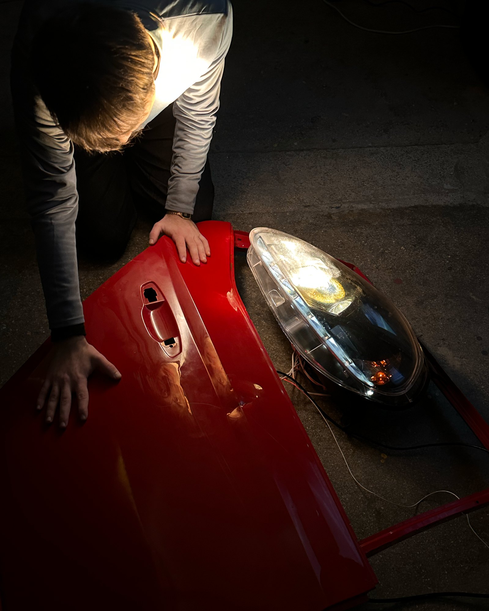 Red car door and headlight used as physical sound objects.