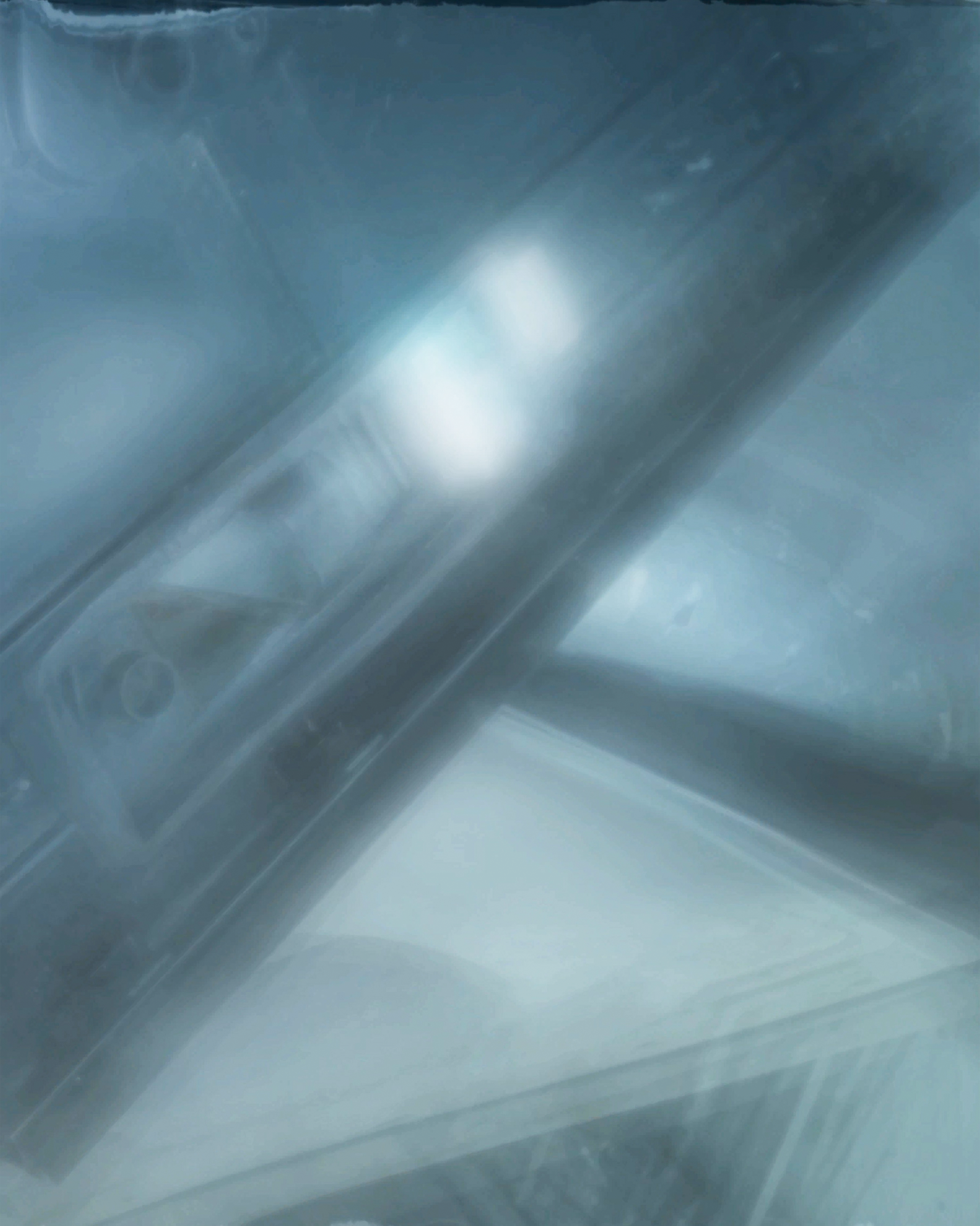 Blue blurred projection still showing car frame shapes.